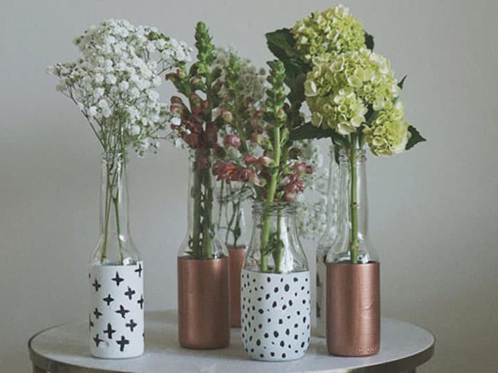 flowers inside beer bottles